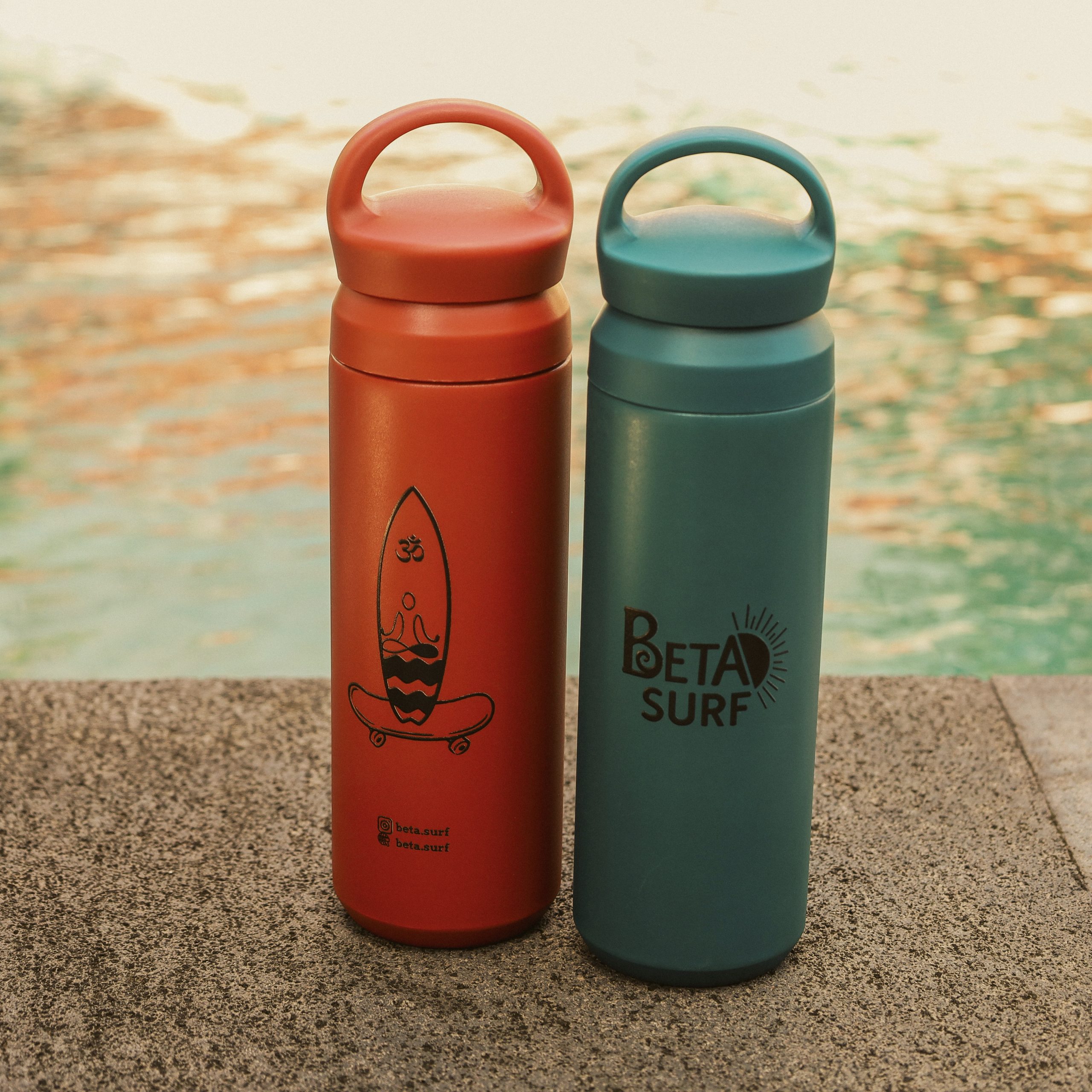 BETA Surf Camp branded water bottles by the poolside