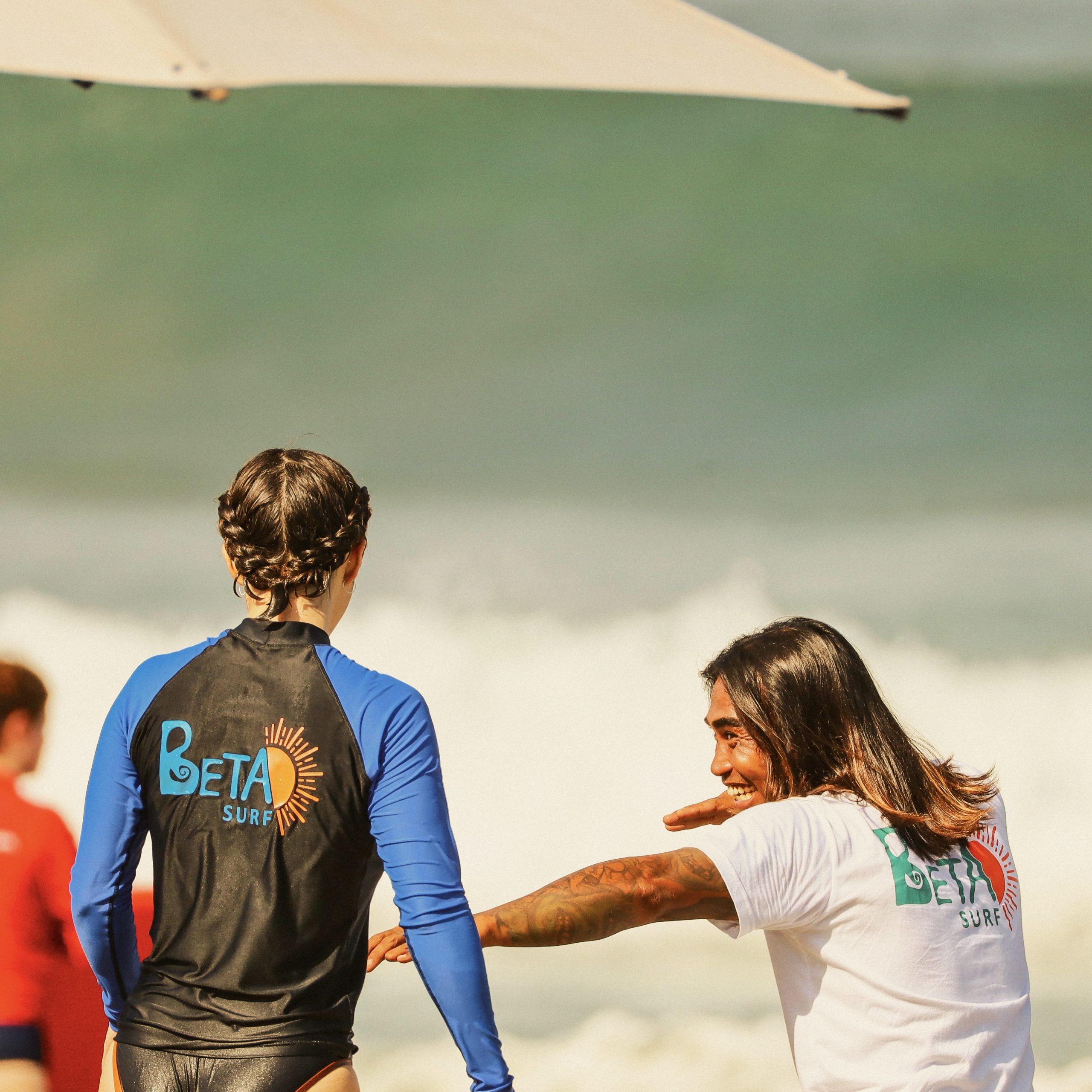 Surf yoga instructor giving one-on-one guidance at BETA Camp