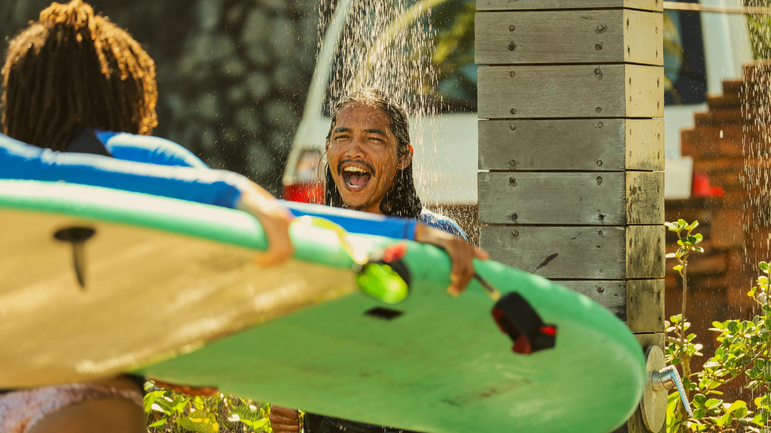 Surf student rinsing off after surf session in Bali at BETA Surf Camp